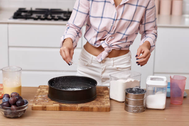 istock baker woman preparing pie in modern kitchen 1919751428