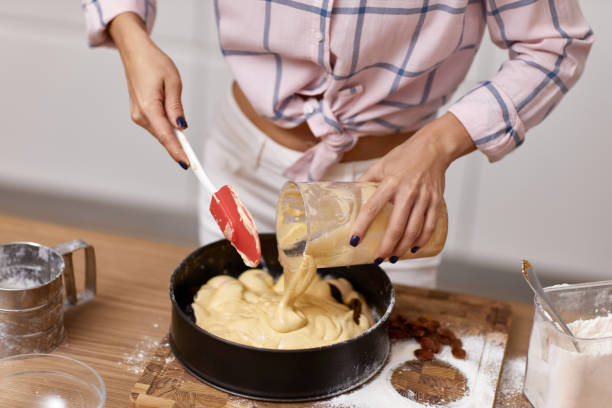 istock baker woman preparing pie in modern kitchen 1919751439