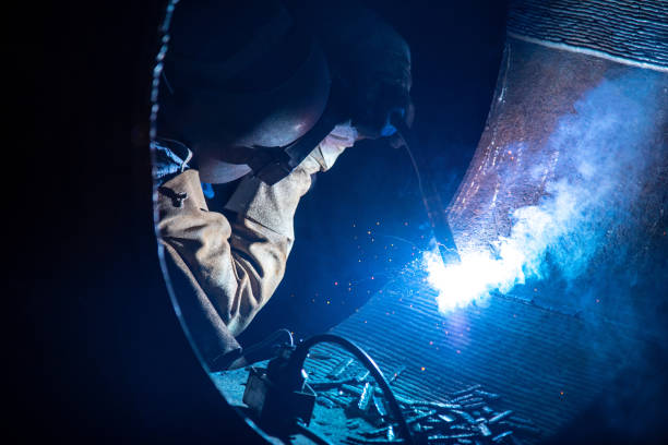 istock Welding steel structures and bright sparks in steel construction industry. 1919782511