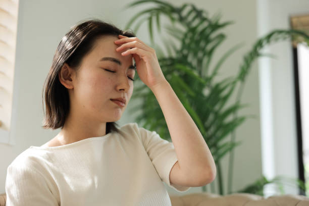 istock Asian woman with headache 1919784728