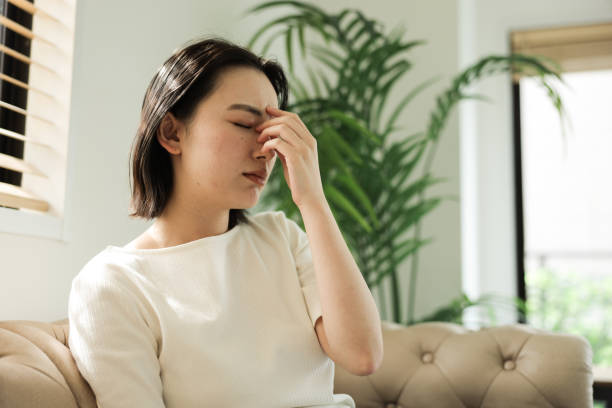 asian woman with headache - 不眠症 ストックフォトと画像