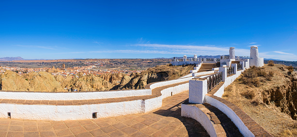 Mirador Cerro de la Bala, to enjoy beautiful views on Guadix, a city in the inland of the Granada province famous for the houses carved in tuff rocks, the white chimney emerging from the ground and the evocative landscapes (5 shots stitched)