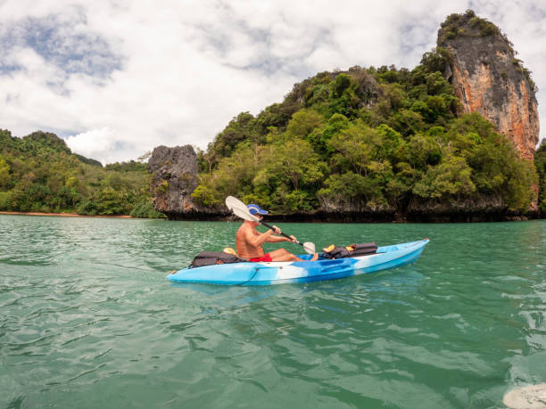 istock Mature man kayaking in tropical scenery 1919807344