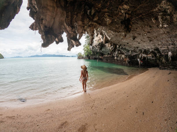 istock Young woman relaxes on a wild beach 1919810691
