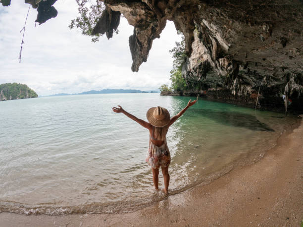 istock Young woman relaxes on a wild beach 1919813044