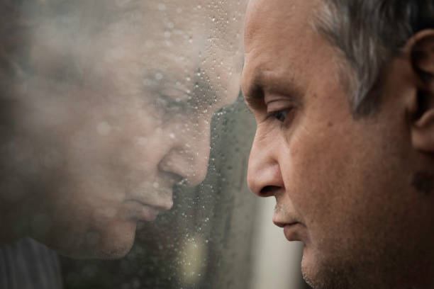 istock Pensive Man Looking out of Window 1919848070