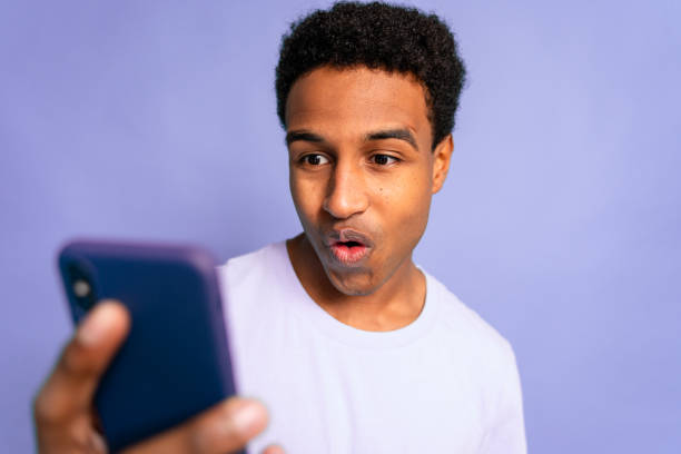 istock Man Astonished by Smartphone Content 1919863315