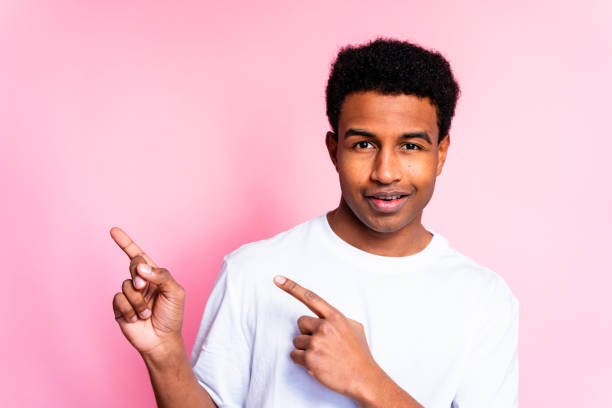 istock Man Pointing to the Side Smiling 1919868121
