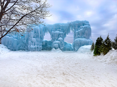 Beautiful ice castle with archway entrance. Winter ice sculpture