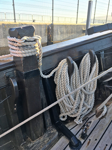 Beautiful Vertical colour image of Detailed Hanging Ropes and Knots of a Nautical Cable Marine - photo taken inside a boat anchored in the Port of Setúbal - Portugal