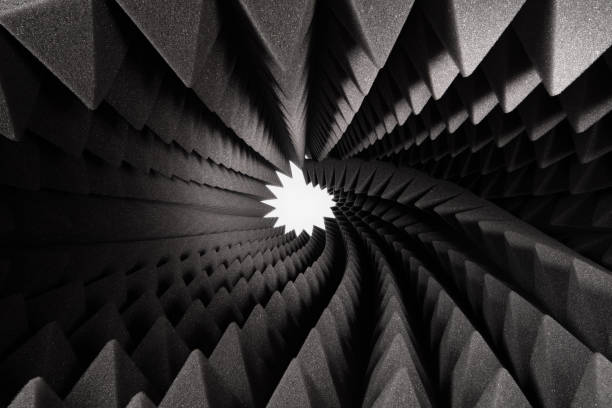 roll of dark gray triangular acoustic foam rubber and light hole. - shock absorber photos et images de collection