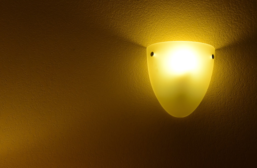 Lamp with yellow light in the corner of the room, room design