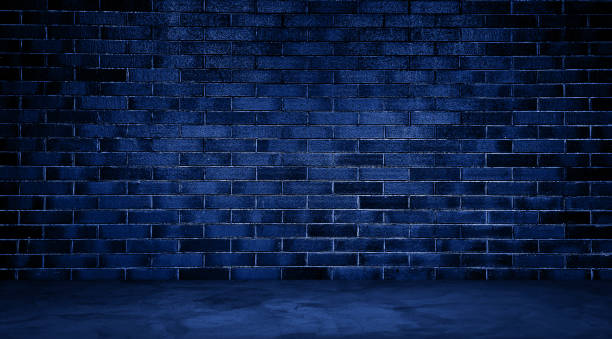 istock dark room with blue concrete floor and blue brick wall background. empty room for montage product displayed in rustic, industrial, loft mood and tone. room interior with blue light for design. 1919905884