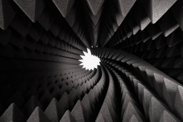 roll of dark gray triangular acoustic foam rubber and light hole. - shock absorber photos et images de collection