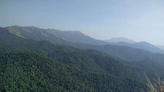 An aerial view of forests and hills in Charmady Ghats on the western ghats of Karnataka, India.