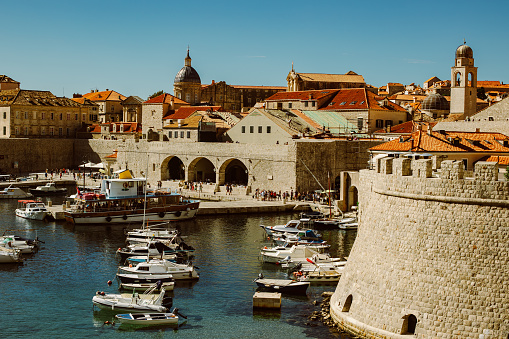 Amazing view of Dubrovnik old city and the boats in a marina on a sunny day. Travel destination in Croatia.