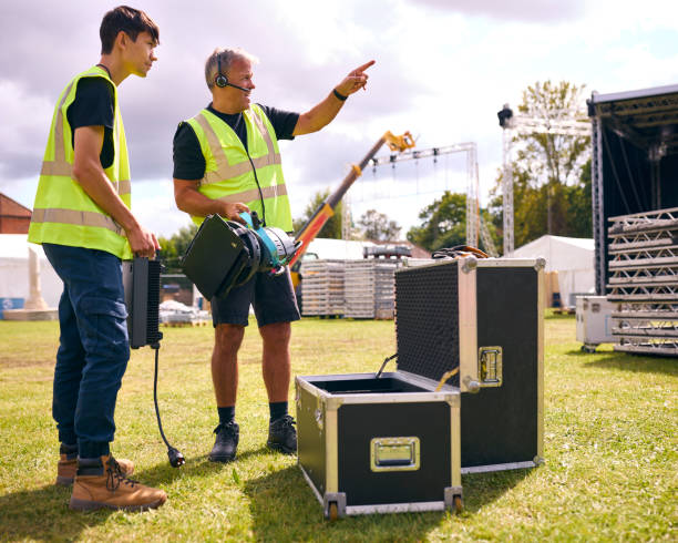 istock Production Team Unpacking Lights From Flight Case And Setting Up Outdoor Stage For Music Festival 1919942822