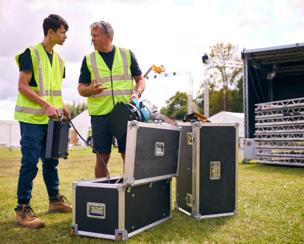 istock Production Team Unpacking Lights From Flight Case And Setting Up Outdoor Stage For Music Festival 1919948730