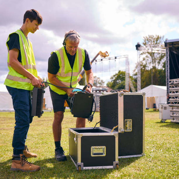 istock Production Team Unpacking Lights From Flight Case And Setting Up Outdoor Stage For Music Festival 1919955144