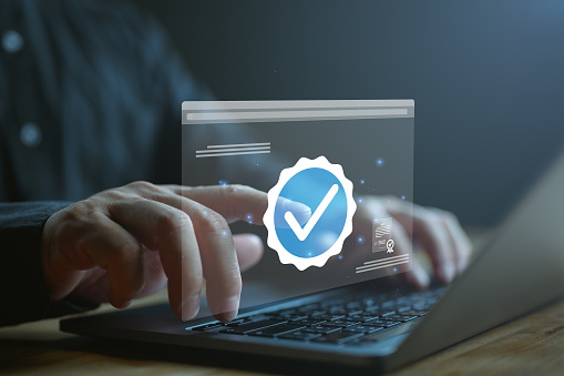 Businessman touch on verification account blue tick checkmark concept, verification account on social media platform, subscription status, eliminate bots and spam, cyber crime, increase credibility.