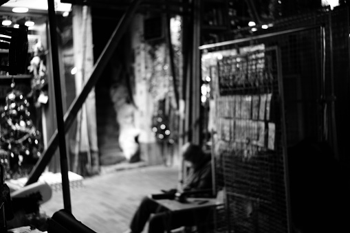 Sleeping man at a market stall by night in Sham Shui Po district, Kowloon Peninsula.
