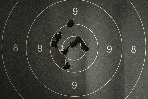 Black target ball with black arrow on dark background