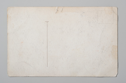 Ancient back of a postcard on a gray background. Flat lay