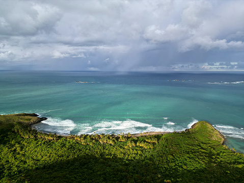 coastal seaside beach view in fajardo puerto rico (seen from above, drone shot, looking down) horizon with waves, rocky outcropping) las cabezas  de san juan nature preserve