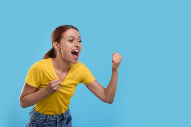 istock Emotional fan celebrating on light blue background, space for text 1920067166