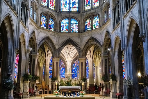 Beautiful church, with a traditional Christmas nativity scene in the center, surrounded by beautiful stained glass windows.