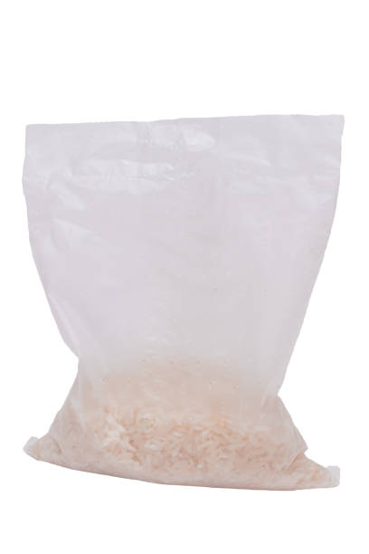 A Plastic Bag of White Long Grain Rice - Isolated on White Background. Small Transparent Package with Dry Rice - Isolation