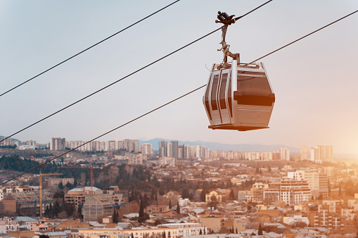 cable car rope way over Georgian capital Tbilisi, aerial view of historical district. High quality picture