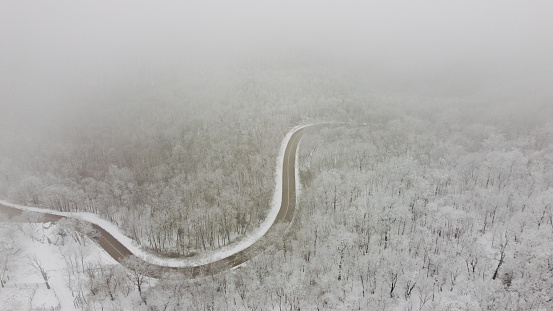 drone view of the road and mountain covered with snow