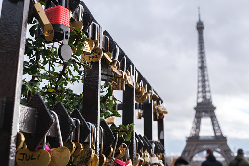 Paris, France - January 1, 2024: Souvenir padlocks, with couples' names written on them, near Trocadero, Paris.