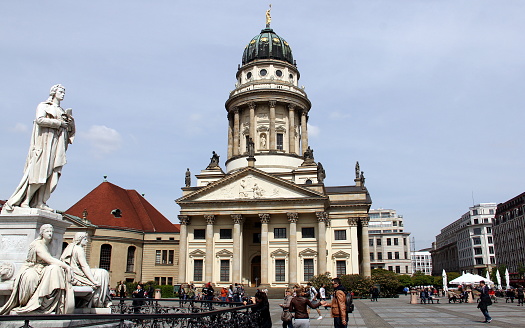Friedrich Schiller monument, left, and French Cathedral, center, on Gendarmenmarkt, Berlin, Germany