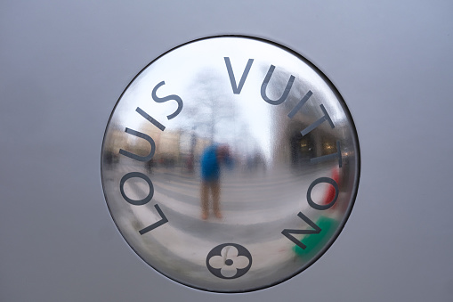 Paris, France - December 31, 2023: Giant Louis Vuitton button on the facade of their store in Paris.