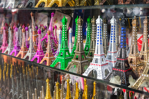 Paris, France - January 1, 2024: Colorful souvenir figurines in the shape of the Eiffel Tower.