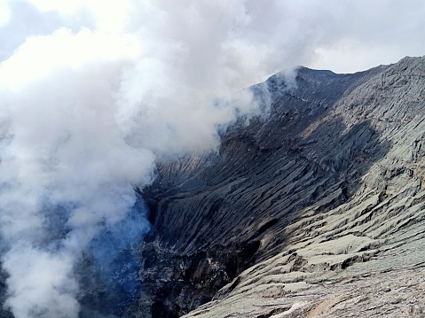 Mountain crater emitting smoke