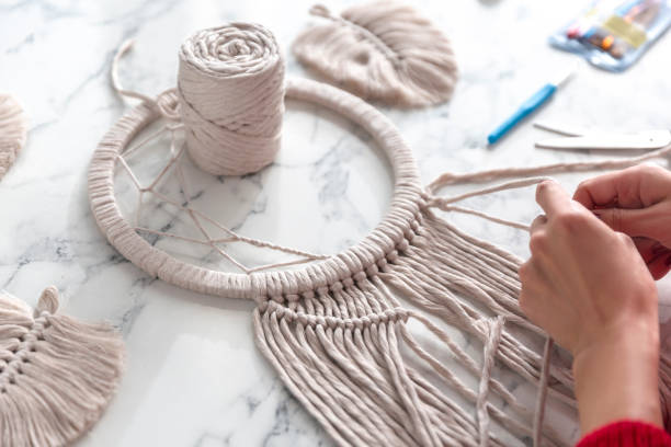 istock Woman weaves macrame. Close up 1920148635