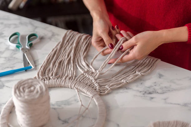 istock Woman weaves macrame. Close up 1920149149