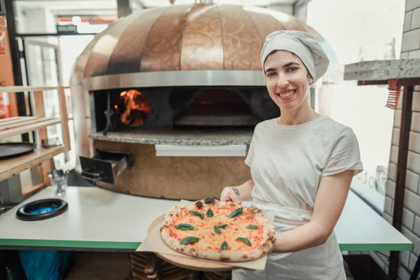 istock Proud chef showing a pizza in a restaurant kitchen 1920151220