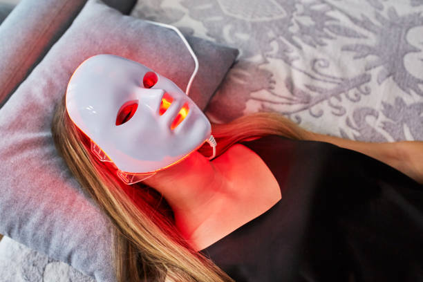 Woman with led light therapy facial beauty mask photon therapy. Home skin care Woman with led light therapy facial beauty mask photon therapy. Home skin care led mask at home with glowing red lights stock pictures, royalty-free photos & images Woman with led light therapy facial beauty mask photon therapy. Home skin care Woman with led light therapy facial beauty mask photon therapy. Home skin care led mask at home with glowing red lights stock pictures, royalty-free photos & images