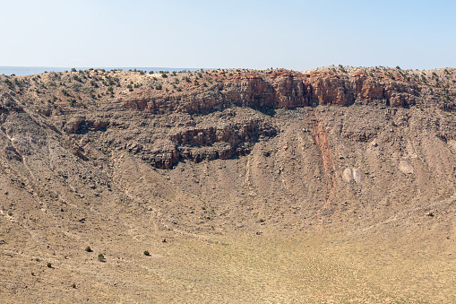 Winslow, Arizona, United States, 13 June 2009:  Images of the Meteor Crater in Arizona capture the awe-inspiring impact site, showcasing a geological wonder formed by a cosmic collision. This natural landmark serves as both a scientific marvel and a testament to Earth's dynamic history, inviting visitors to explore the intersection of space and our planet's geological evolution.