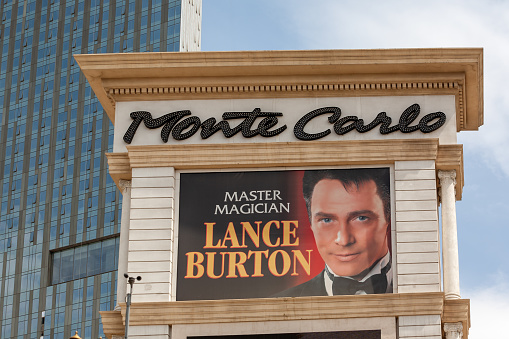 Las Vegas, Nevada, United States - 16 Jun 2009: An image featuring the Monte Carlo sign on the Vegas Strip with an advertisement for magician Lance Burton.