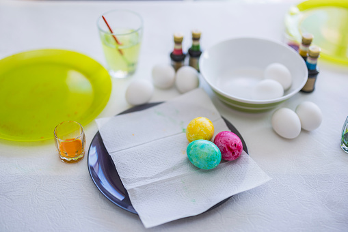 Close-up view of Easter eggs lying on the table in a plate, painted by a child. Sweden.