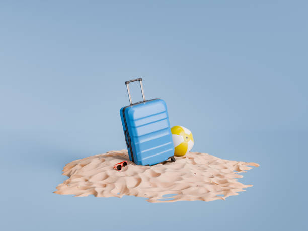 istock Blue Suitcase and Beach Ball on Sand Pile, Vacation Concept 1920254401