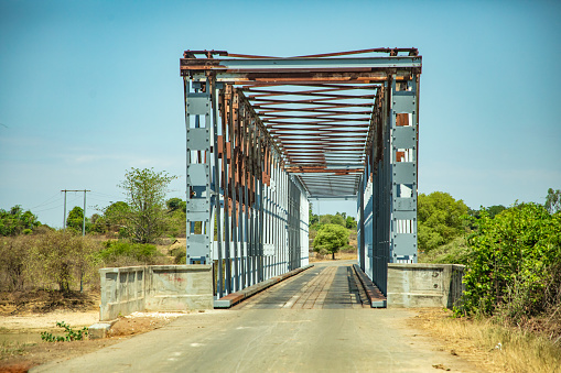 Antsirabe, Madagascar 19 october 2023. Road from Morondava to Antsirabe. large iron arches of bridge over river