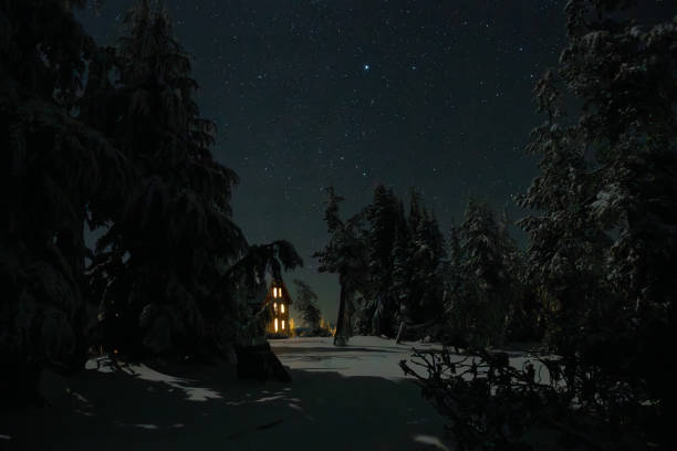 The Crater Lake Lodge under a starry sky after a fresh snowfall