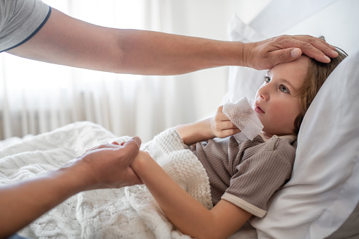 Little boy ill at home with a virus or infectious disease