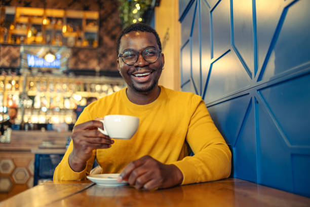 istock Happy man drinking a cup of coffee at a cafe 1920320712
